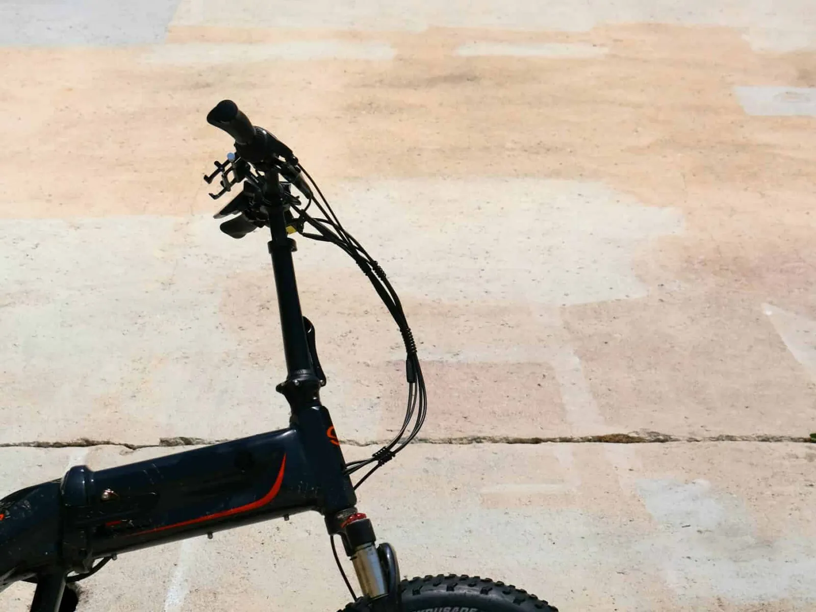 Folding e-bike on a sunlit sidewalk